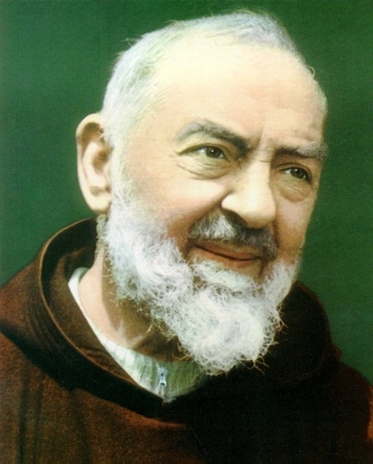 A photographic portrait of Padre Pio in his brown Capuchin habit, white-bearded, looking upward with a gentle smile
