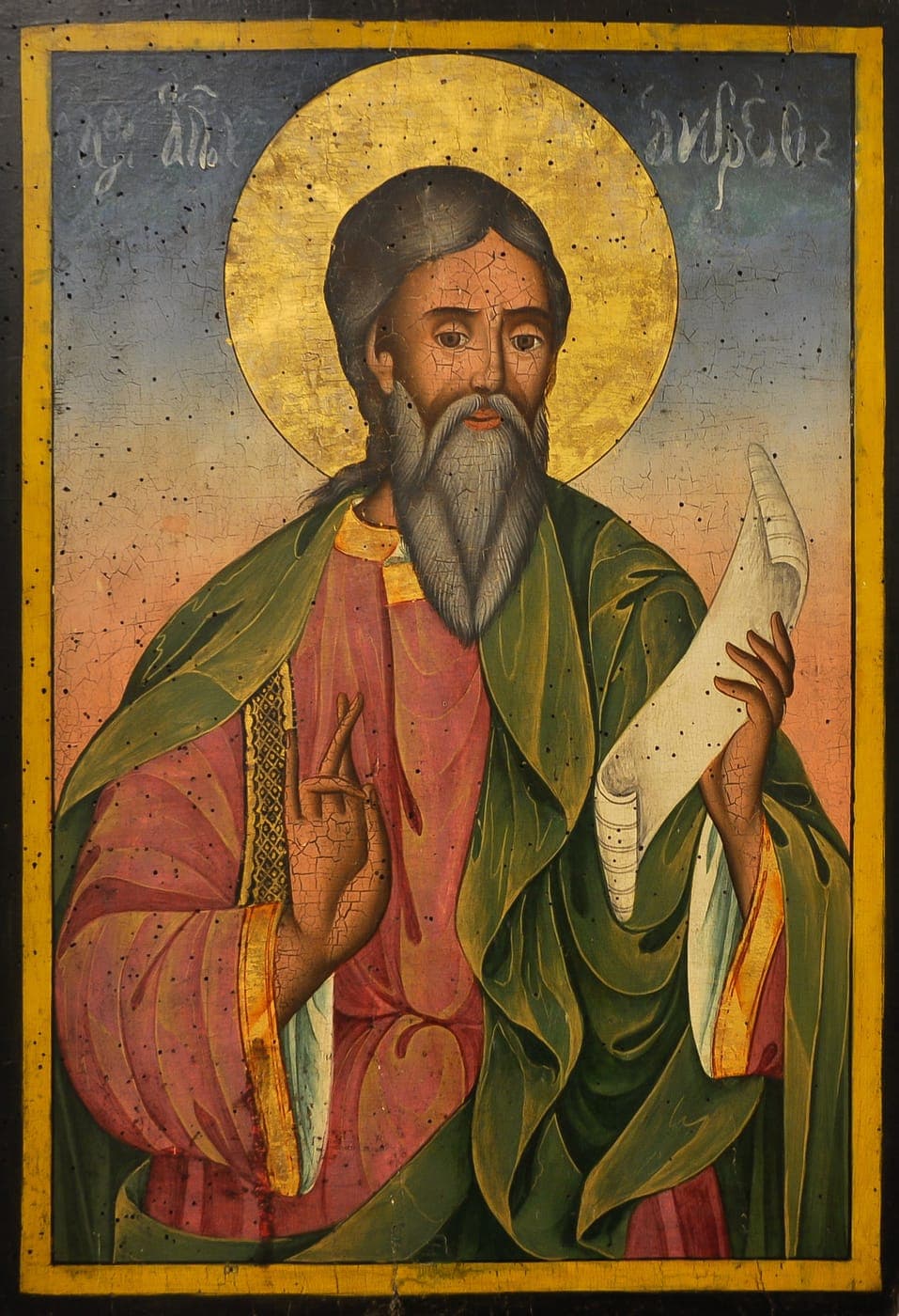 A nineteenth-century Bulgarian icon of St. Andrew the Apostle in a green mantle over a rose tunic, a gold halo behind his head, holding a scroll in his left hand and raising his right in blessing