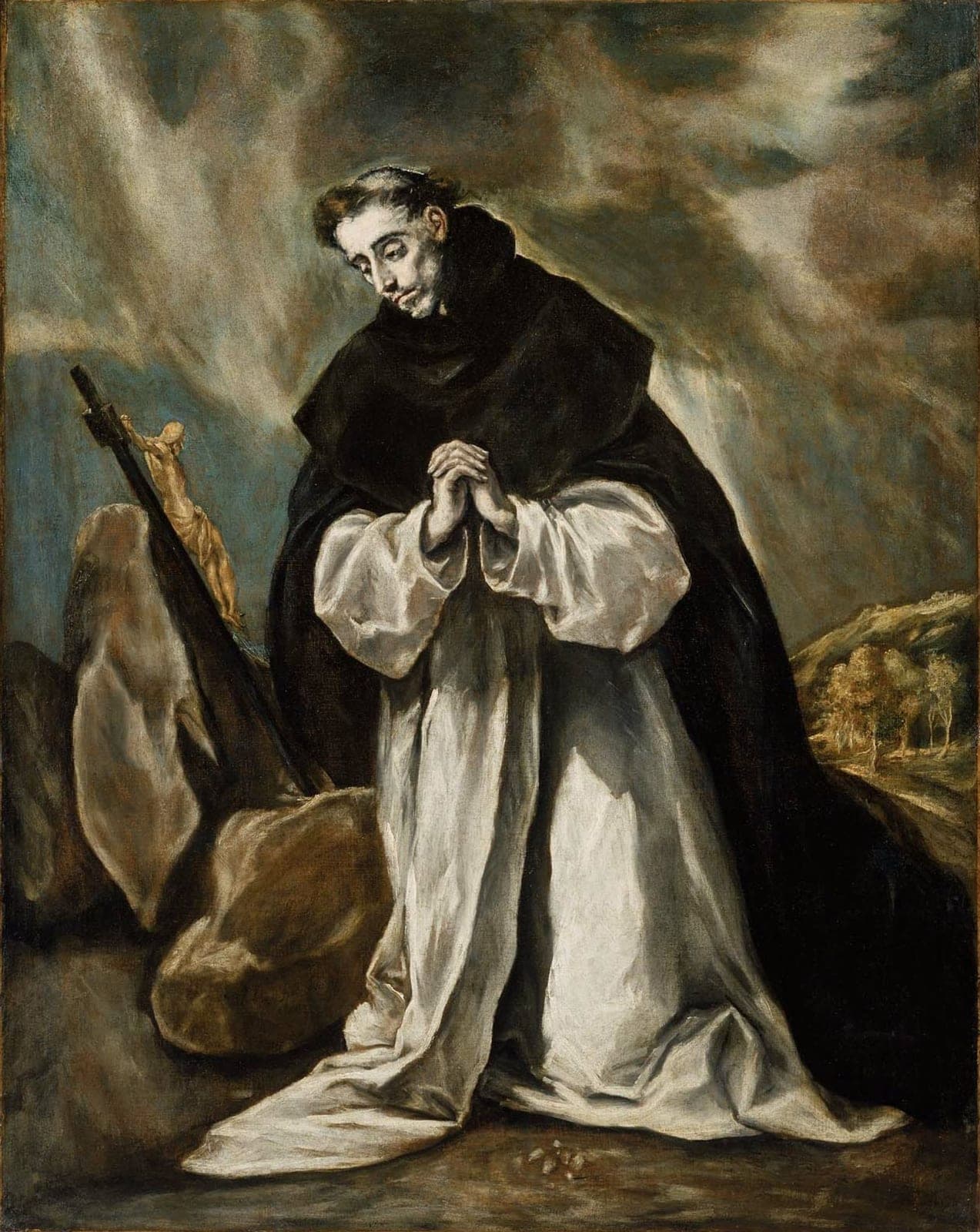 El Greco's painting of St. Dominic kneeling in prayer in his black and white Dominican habit before a crucifix, under a stormy sky