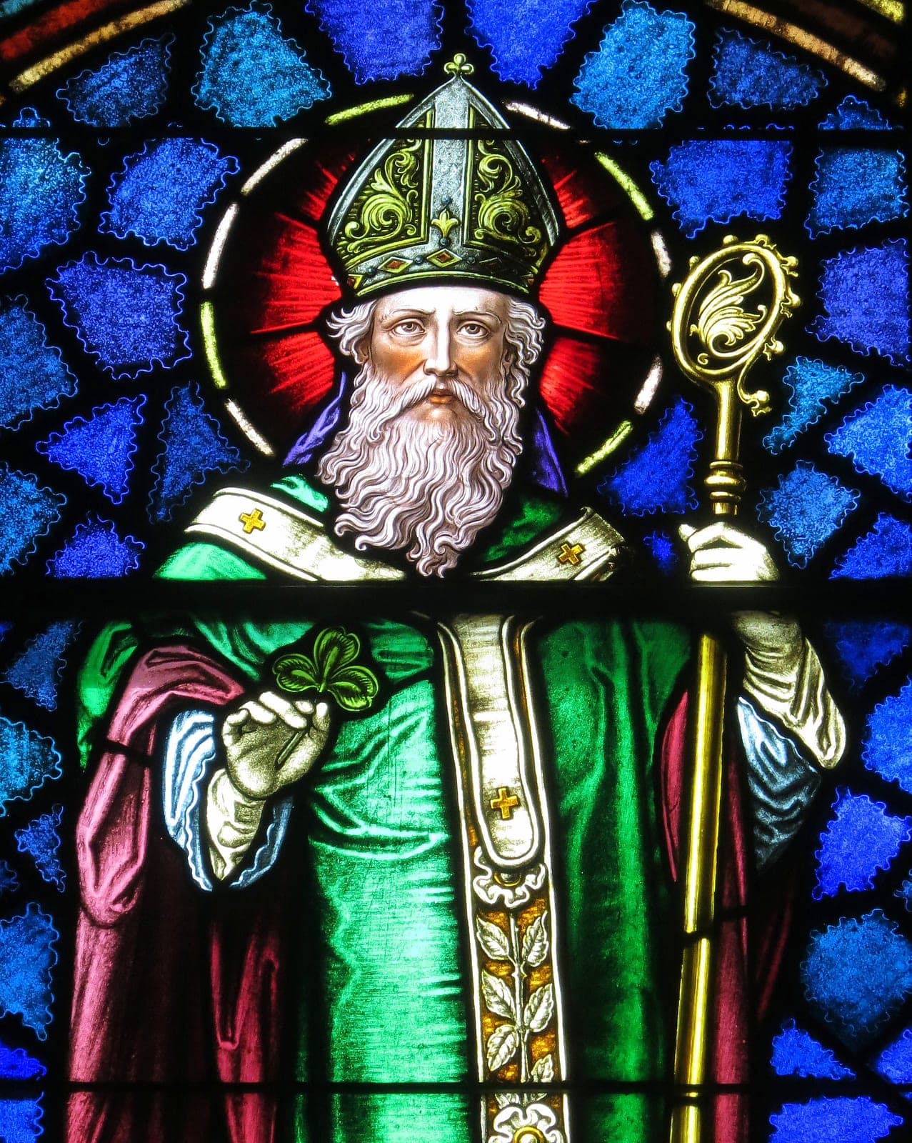 St. Patrick in bishop's vestments holding a shamrock and crozier