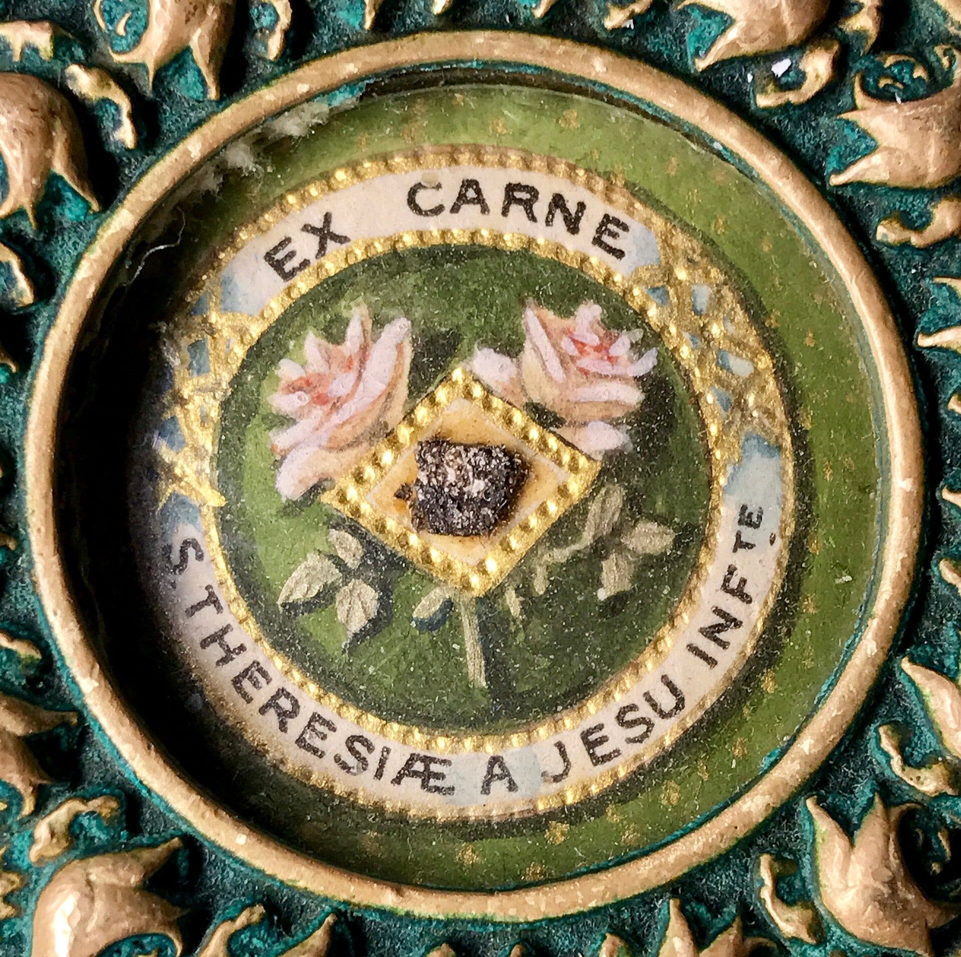 A first-class relic of St. Thérèse in an embroidered theca, inscribed EX CARNE S. THERESIAE A JESU INFANTE